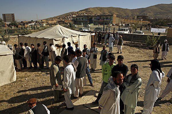Voters begin to line up as the polls open on the outskirts of Kabul, the capital.