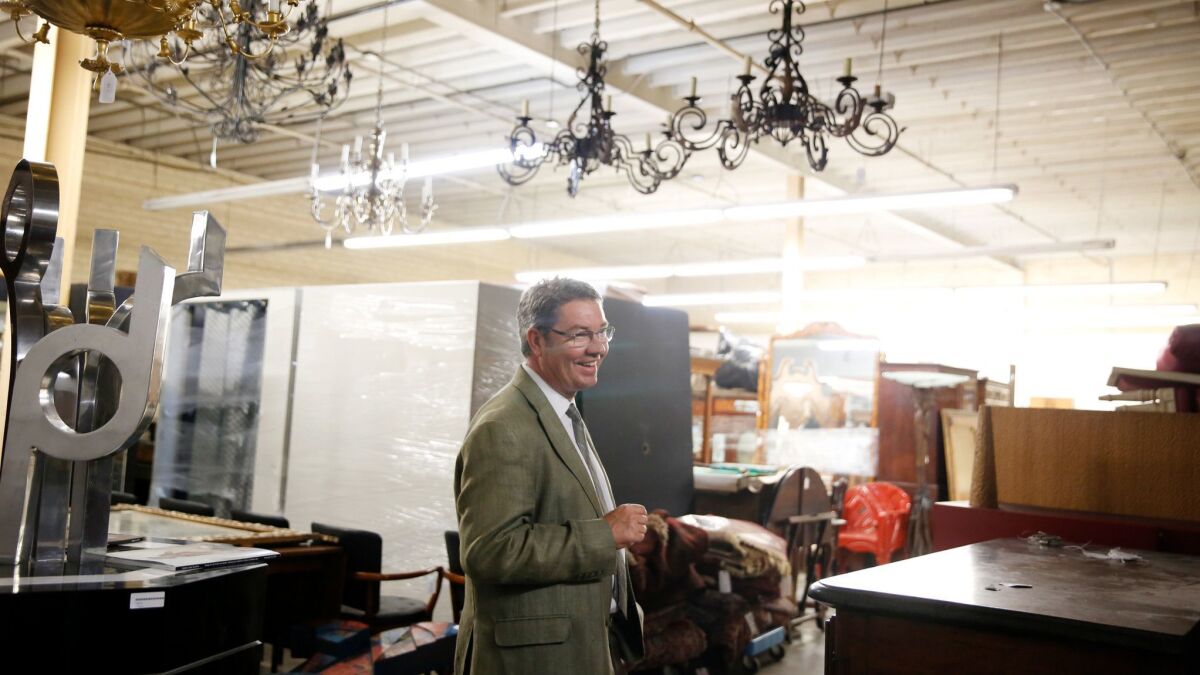 Andrew Jones, who has spent nearly three decades in the auction business, walks through his warehouse.