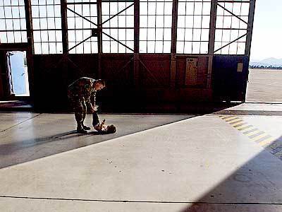 Sgt. Maj. John Isberter entertains daughter Erin, 2, in a hangar at the former Norton air base in San Bernardino. The last time a California National Guard unit was sent into combat was in the Korean War.