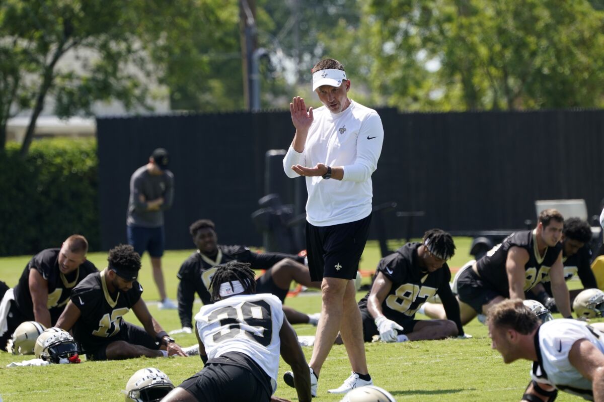 New Orleans Saints head coach Dennis Allen talks to running back DaMarcus Fields (39) as they warm up during an NFL football practice in Metairie, La., Thursday, June 2, 2022. (AP Photo/Gerald Herbert)