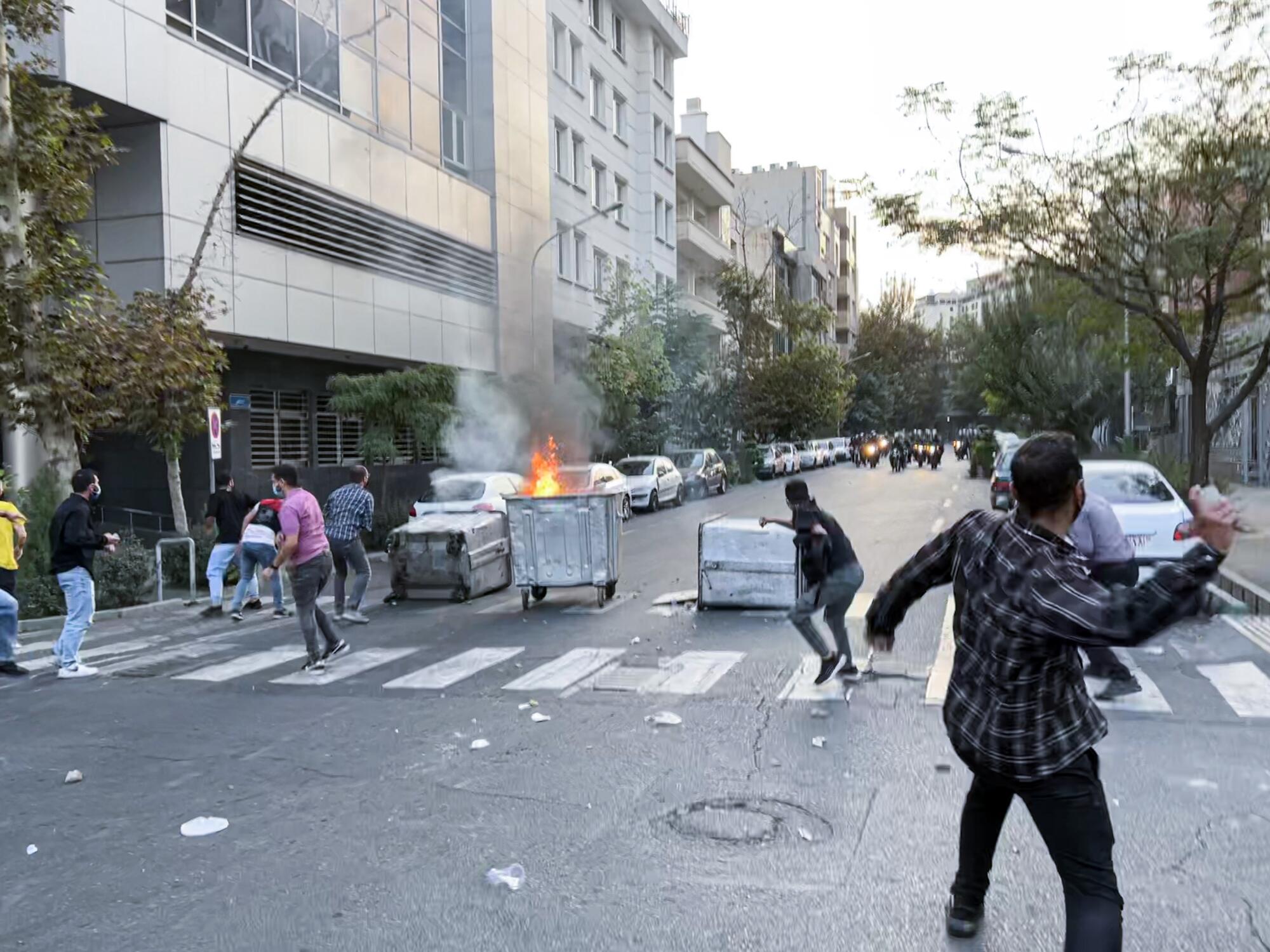 People gather during a protest for Mahsa Amini, who died after being arrested by morality police