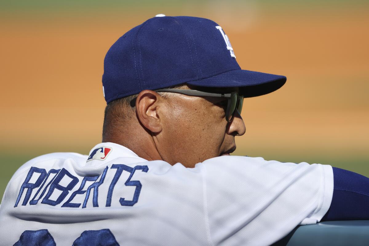 Dodgers manager Dave Roberts looks on from the dugout on Oct. 19, 2021.