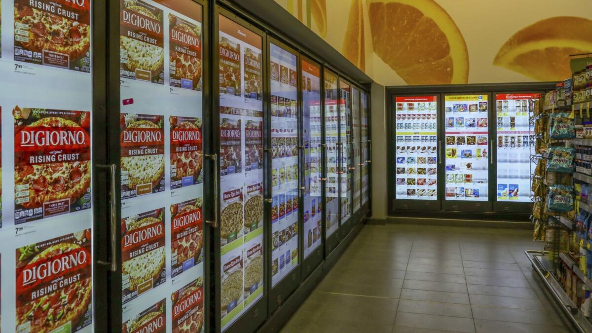 At this Walgreen's in Chicago, a smart-shelf area has cooler doors with cameras and sensors. The doors' video screens display images of the coolers' contents and could show ads as well.