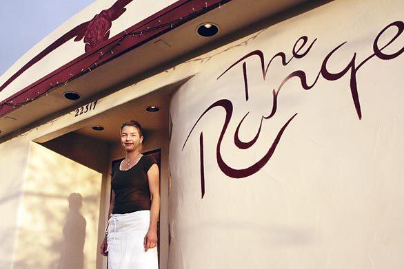 Lindsay Jackson stands by the entrance to the Range, a steakhouse in wine country just north of San Louis Obispo. her husband, Jeff Jackson, is the chef.