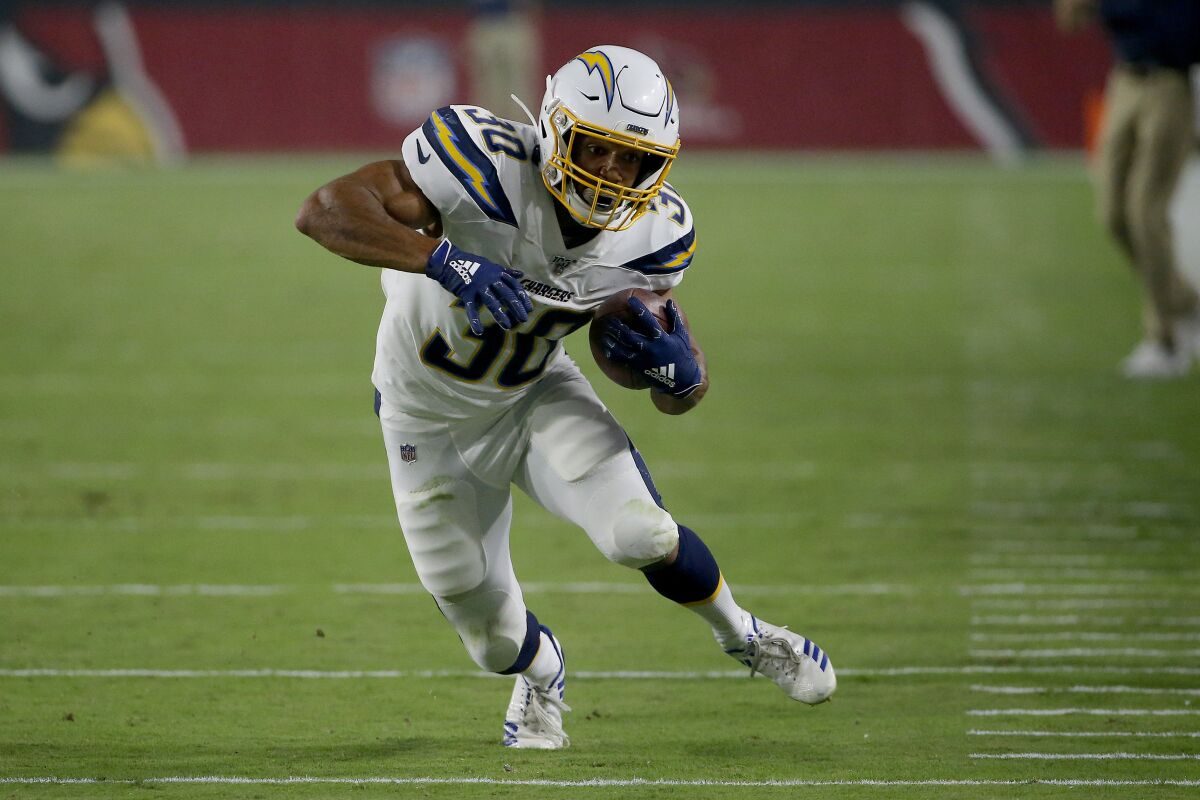 Chargers running back Austin Ekeler carries the ball against the Cardinals.