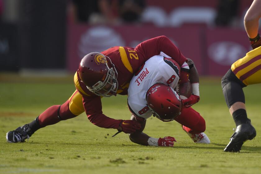USC linebacker Su'a Cravens, left, tackles Utah wide receiver Bubba Poole on Oct. 24.