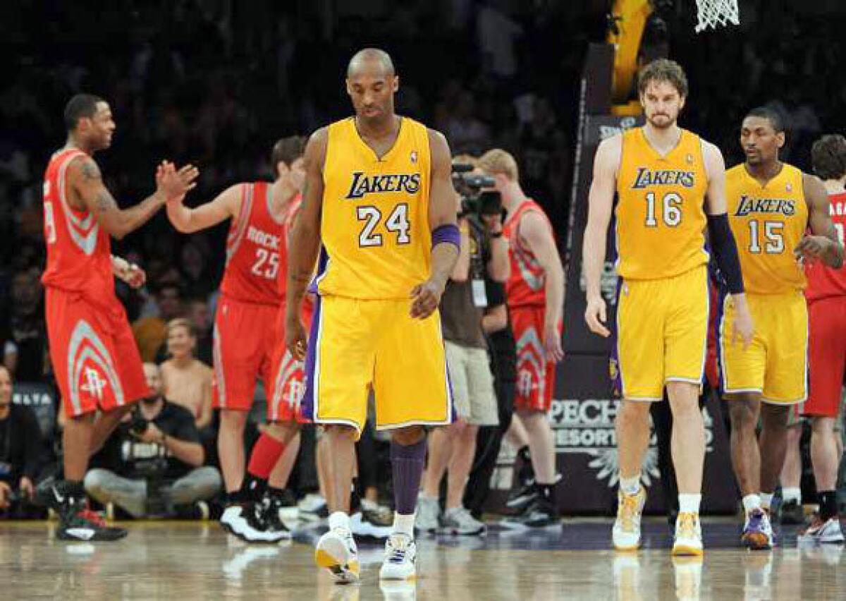 Kobe Bryant, Pau Gasol and Metta World Peace leave the court after a loss to the Houston Rockets in April.