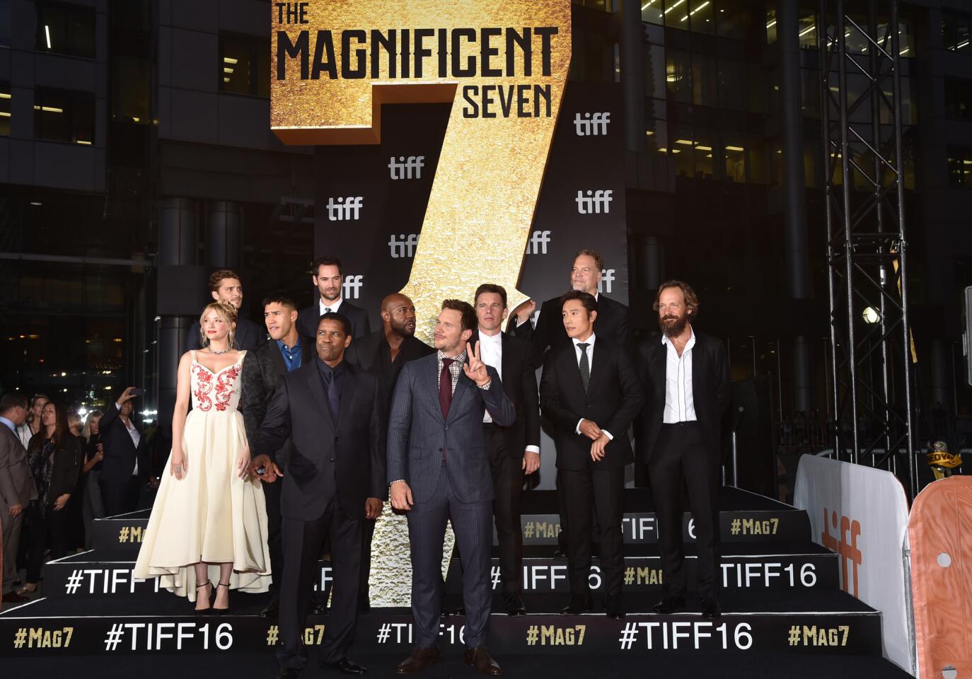 Lucas Grimes, back row from left, Manuel Garcia-Rulfo, Vincent D'Onofrio; center row from left, Haley Bennett, Martin Sensmeier, Antoine Fuqua, Ethan Hawke, Byung-hun Lee, Peter Sarsgaard; and front row from left, Denzel Washinton and Chris Pratt attend "The Magnificent Seven" premiere on Day 1 of the Toronto International Film Festival at the Roy Thomson Hall in Toronto.