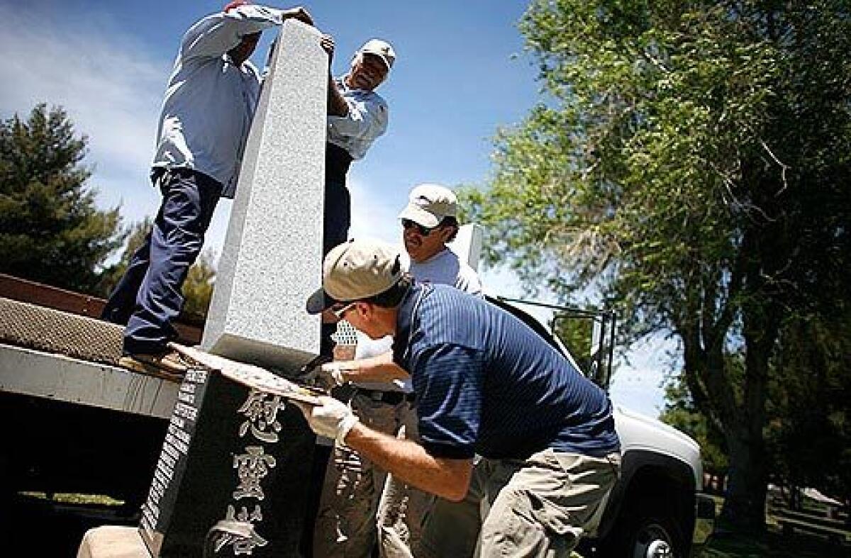 A new monument is erected at the Lancaster Cemetery by employees of the cemetery and a monument company. Members of Los Angeles Countys Japanese American community, the West Antelope Valley Historical Society, a local Rotary club, and area school children helped raise funds to have the monuments white granite obelisk replaced.