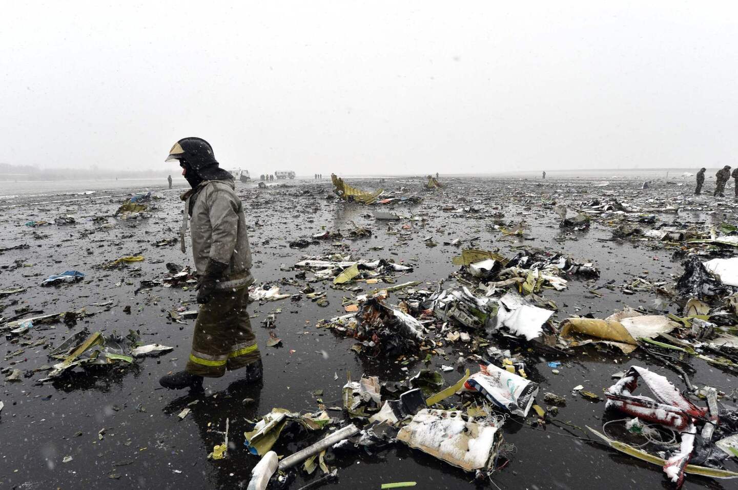 A Russian emergency worker walks through wreckage of the FlyDubai passenger jet that tried to land in bad weather in the city of Rostov-on-Don.