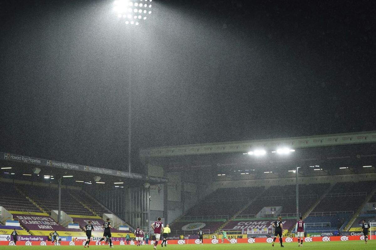 Heavy rain falls during the English Premier League soccer match between Burnley and West Ham United and at Turf Moor stadium in Burnley, England, Monday, May 3, 2021. (AP Photo/Jon Super, Pool)