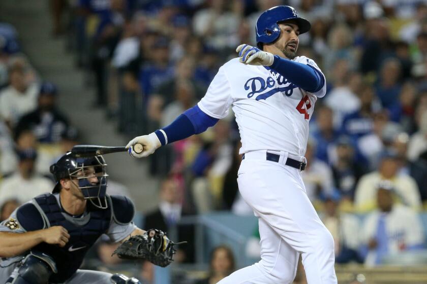 Dodgers first baseman Adrian Gonzalez follows through on a run-scoring single against the Mariners in a game April 15.