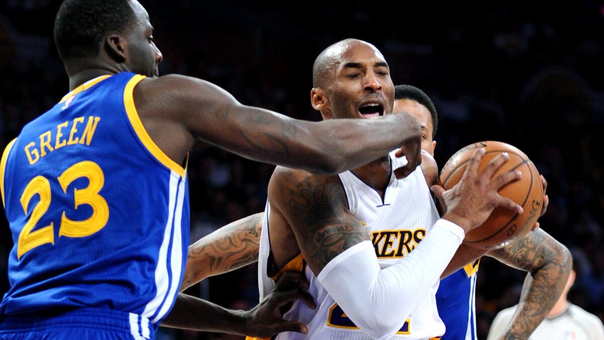 Kobe Bryant gets hit above the eye by Golden State Warriors forward Draymond Green during the Lakers' 136-115 loss at Staples Center on Nov. 16.