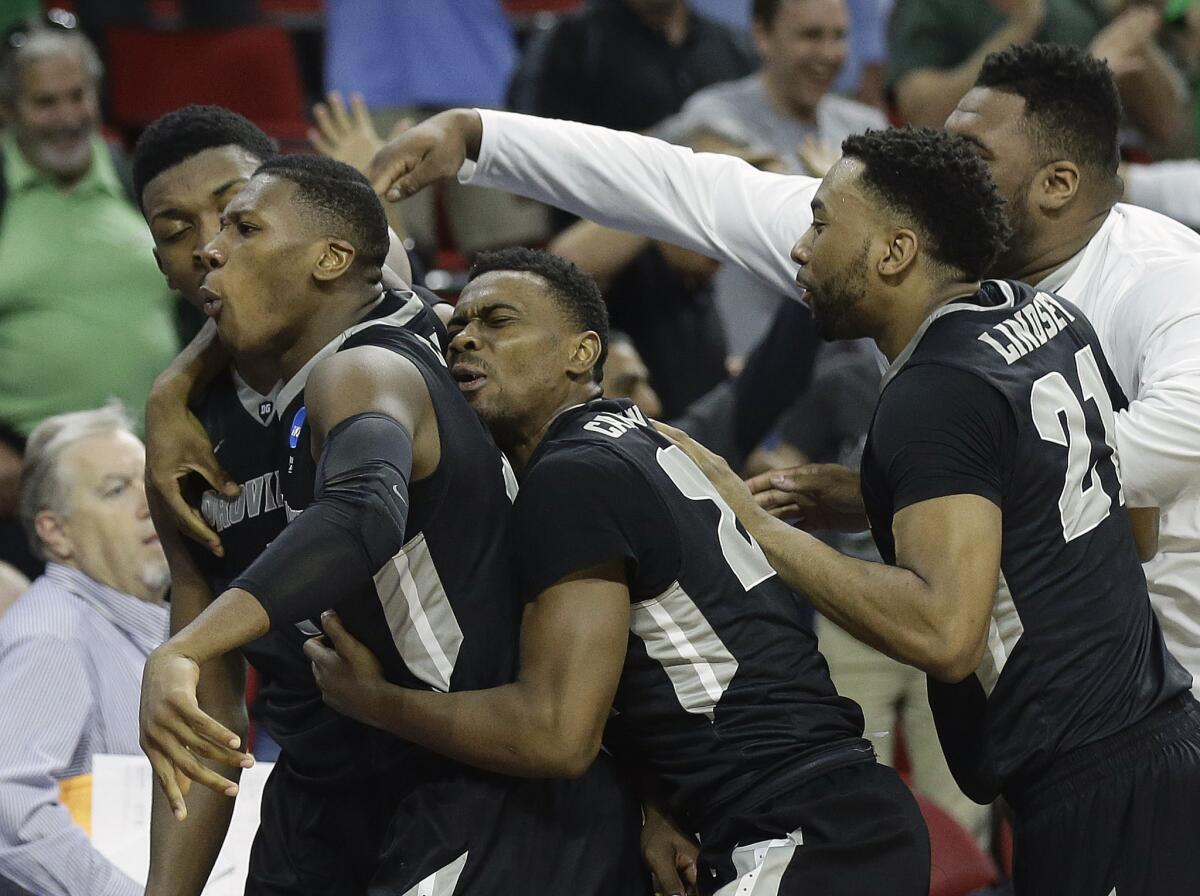 Providence forward Rodney Bullock is swarmed by teammates after hitting the game-winning basket against USC in the final second Thursday night.