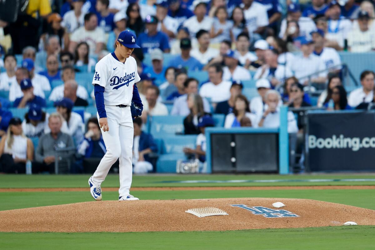 Yoshinobu Yamamoto reacts after allowing a two-run home run to Manny Machado in the first inning of Game 1 on Saturday.