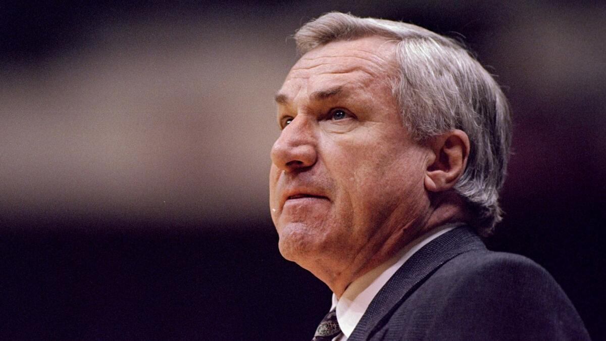 North Carolina Coach Dean Smith looks on during an NCAA tournament game against Texas Tech on March 17, 1996.