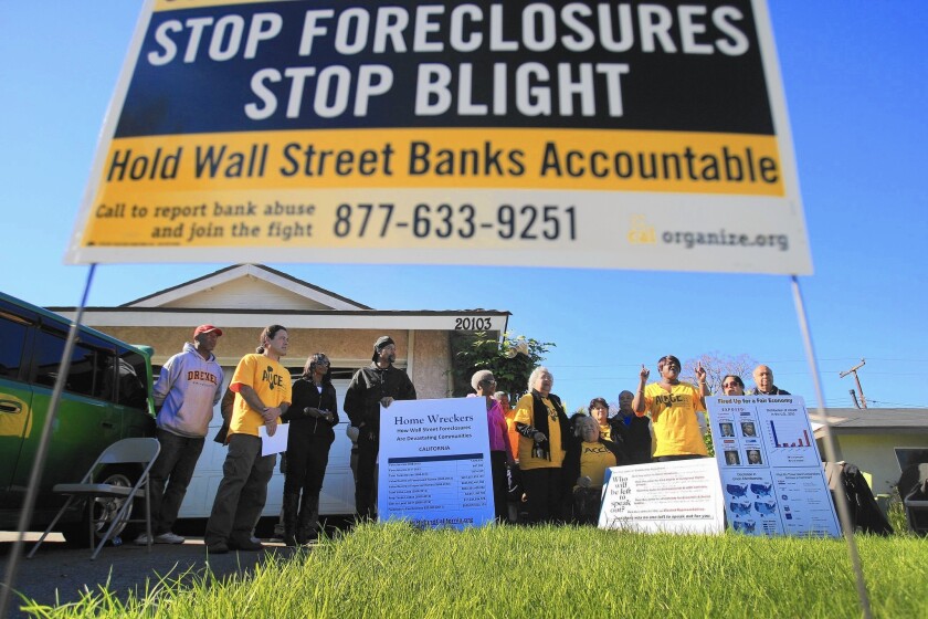 Experts said it’s highly unlikely that former homeowners could unravel their foreclosures and win back their houses. Above, advocacy group Alliance of Californians for Community Empowerment holds a news conference in Carson in 2012.