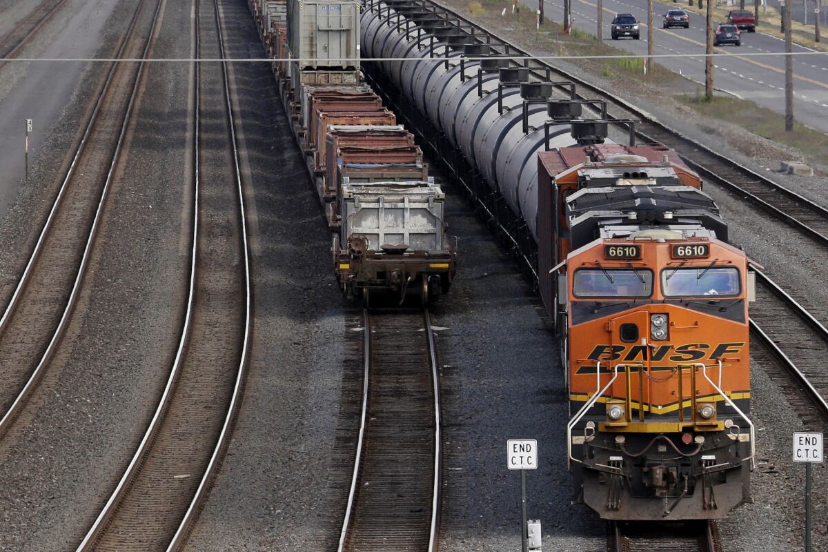 FILE - In this July 27, 2015, file photo, a BNSF Railway Company train is parked in Seattle. The head of the nation's largest railroad union says the report designed to help resolve stalled contract talks with freight railroads didn't do enough to address concerns about working conditions even though it recommended 24% raises, Thursday, Aug. 18, 2022.(AP Photo/Elaine Thompson, File)