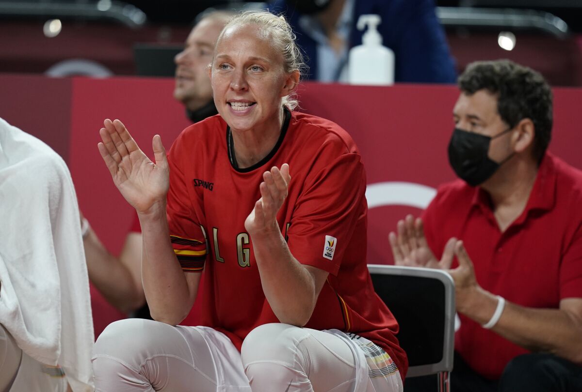 Belgium's Ann Wauters (12) cheers for her teammates as she sits on the bench during women's basketball preliminary round game between Belgium and Puerto Rico at the 2020 Summer Olympics, Friday, July 30, 2021, in Saitama, Japan. (AP Photo/Charlie Neibergall)