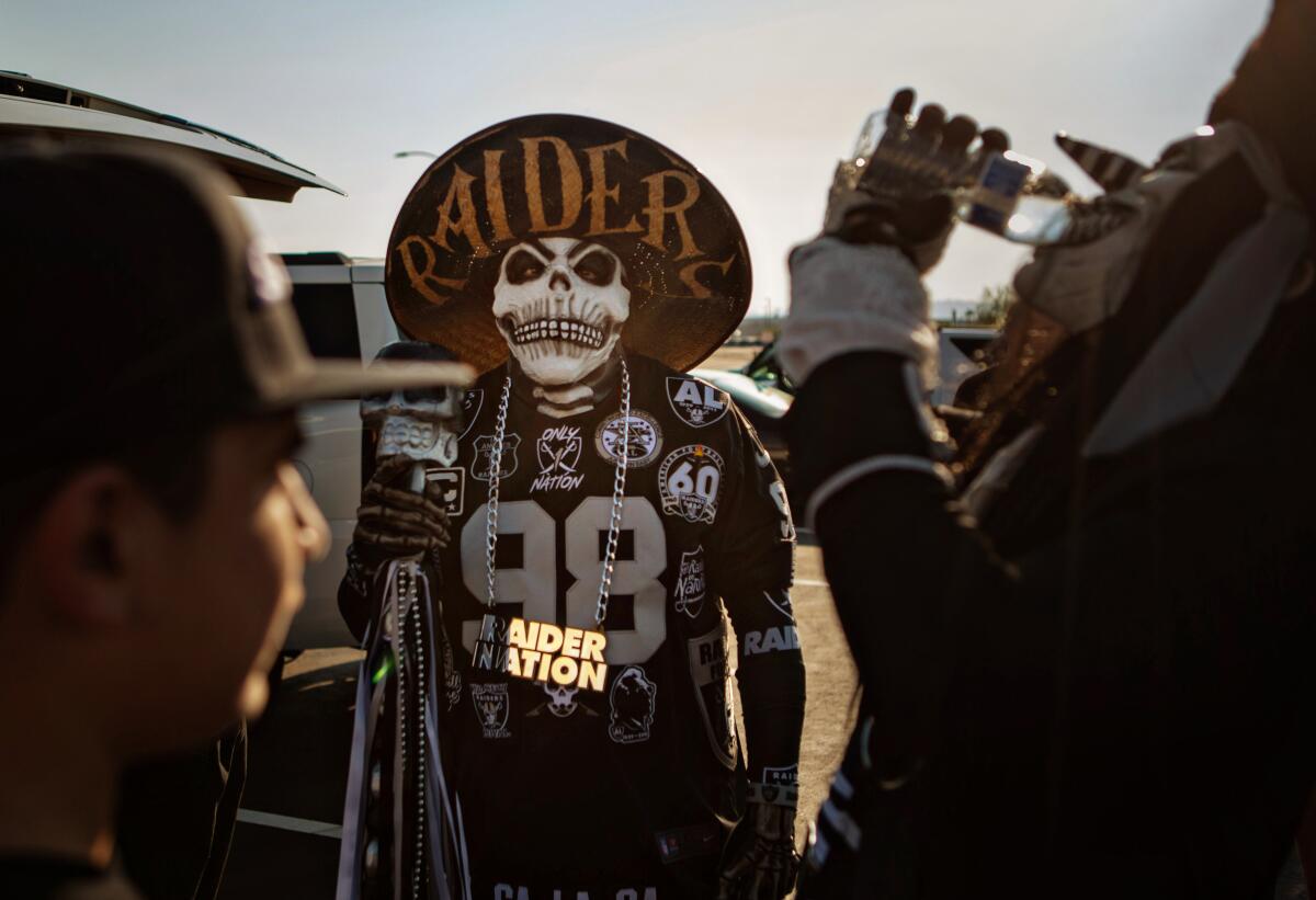 A group of Las Vegas Raiders fans gather outside Allegiant Stadium in Las Vegas on Aug. 27.