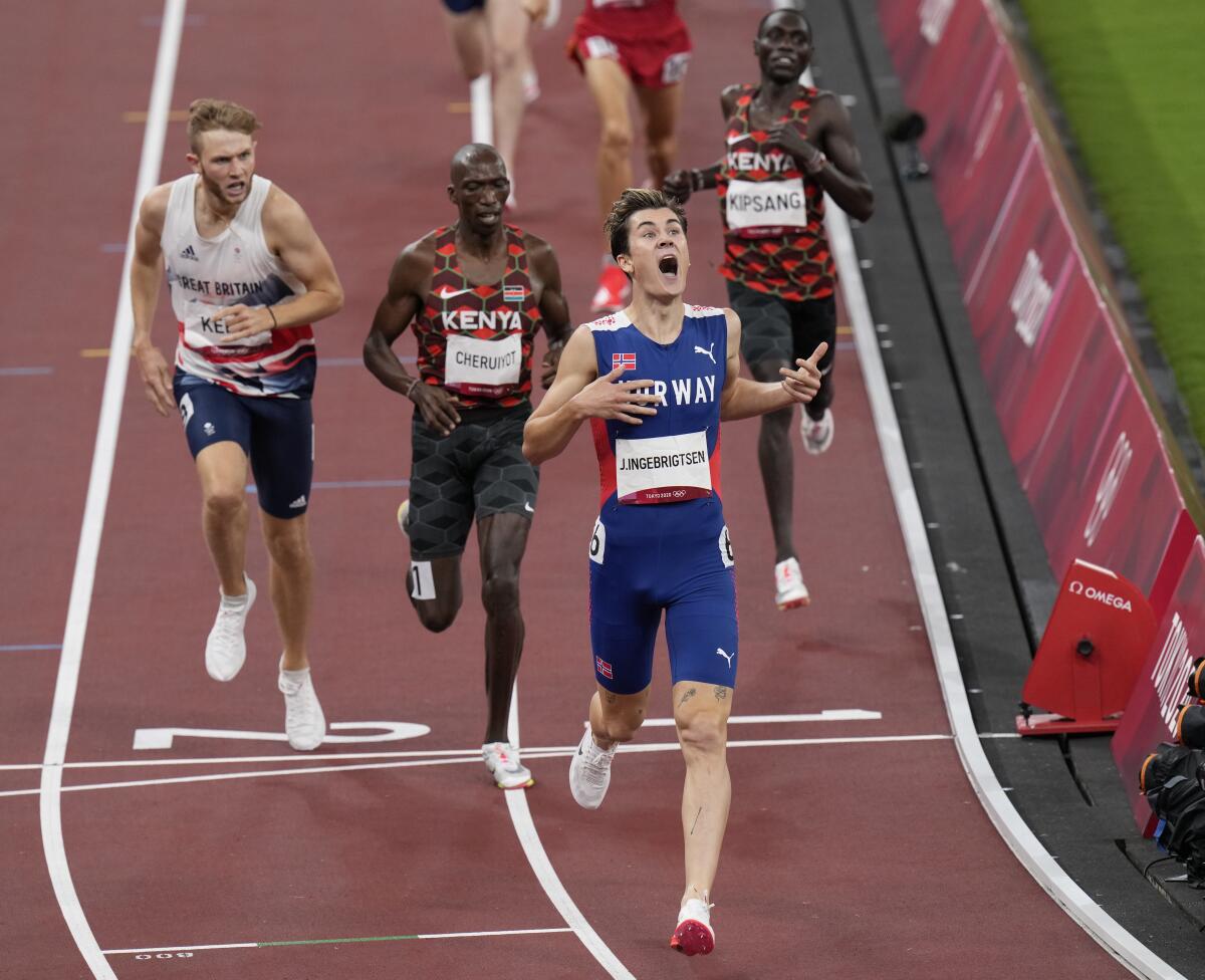 Jakob Ingebrigtsen looks exultant as he crosses the finish line at the Tokyo Olympics.