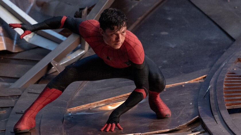 A man dressed as Spider-Man crouches in the movie "Spider-Man: No Way Home."