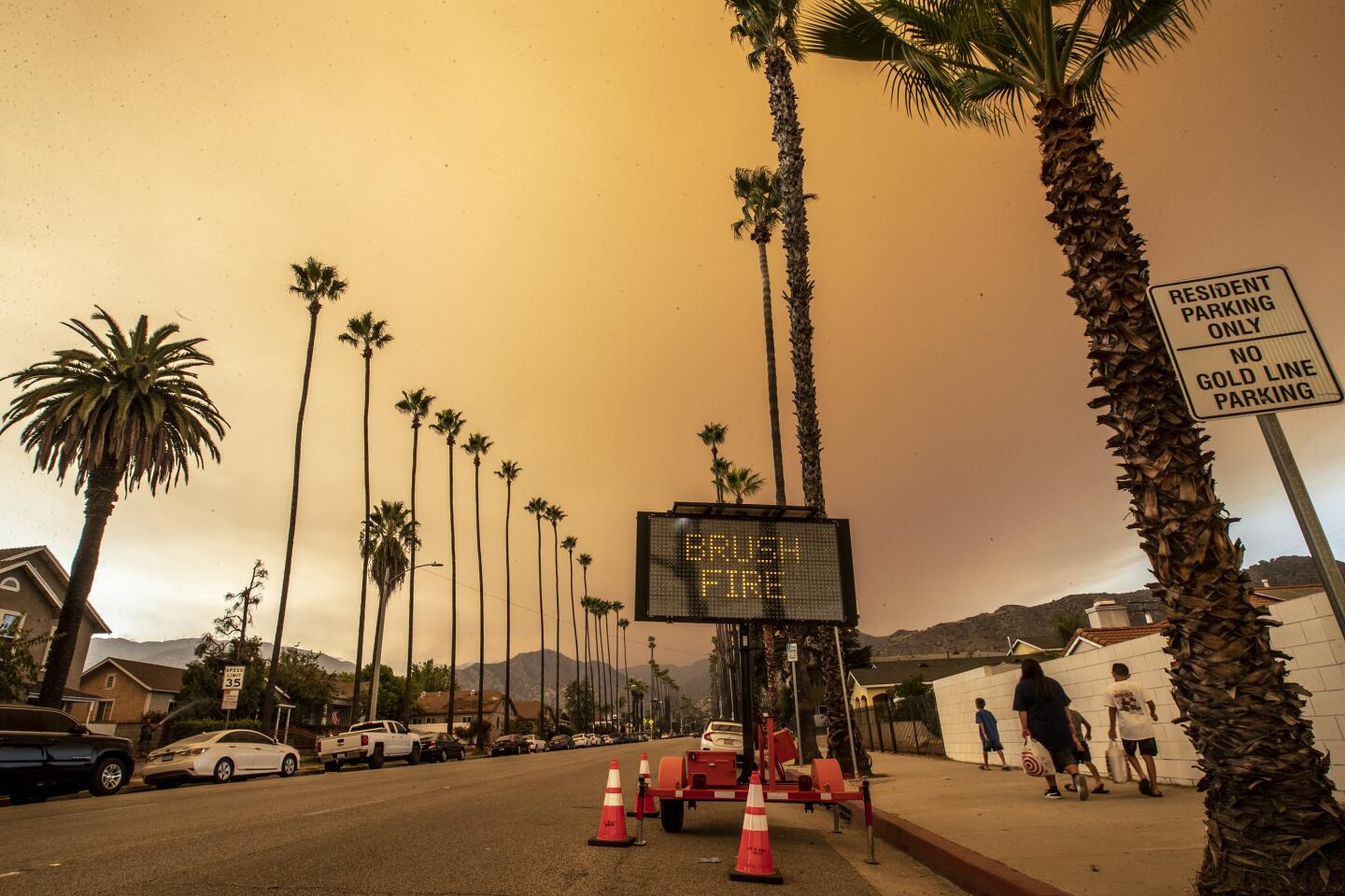 Haze from the Bobcat fire looms over a street.