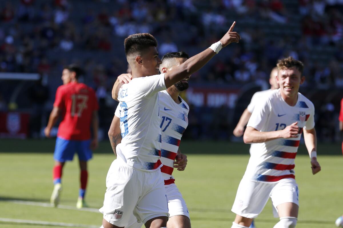 USA's Ulysses Llanez, left, celebrates after scoring  against Costa Rica in a February friendly match in Carson.