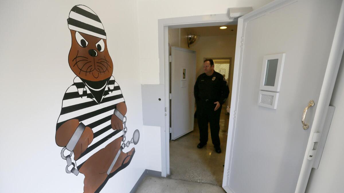 Sgt. Steve Bowles shows off a room where "pay-to-stay" inmates can watch television, socialize and play games at the Seal Beach Detention Center.