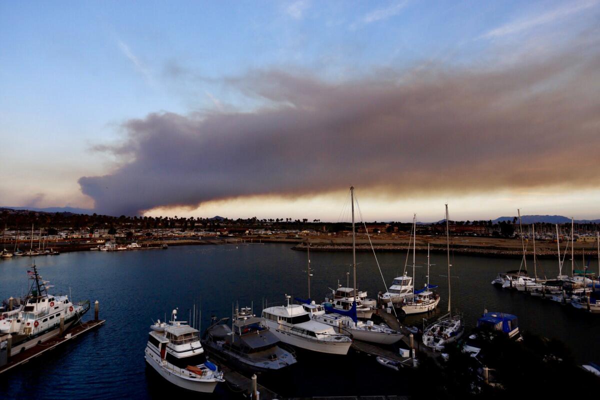 Thomas Fire smoke rises from the Santa Paula and Filmore area as seen from Ventura Harbor.