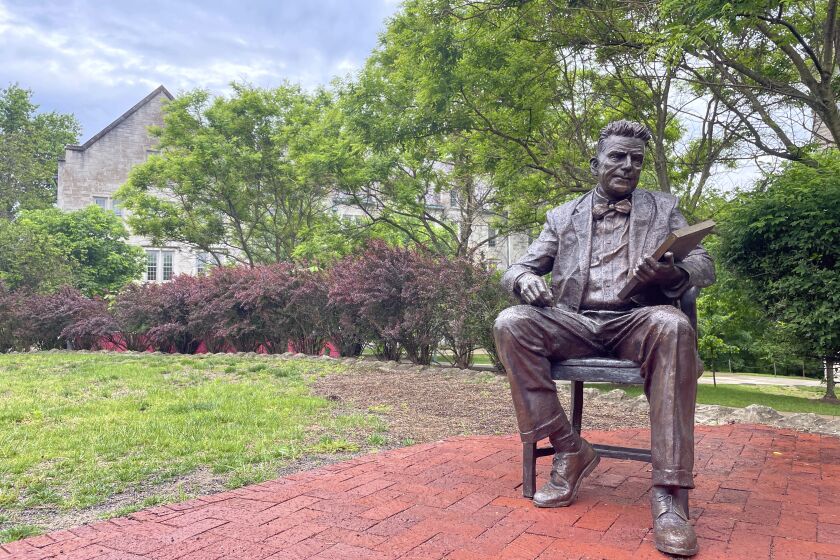 A bronze sculpture of Alfred Kinsey, a sex researcher who founded Indiana University's branch of sex research, the Kinsey Institute, sits outside the institute's research facility, Tuesday, May 16, 2023, in Bloomington, Ind. (AP Photo/Arleigh Rodgers)