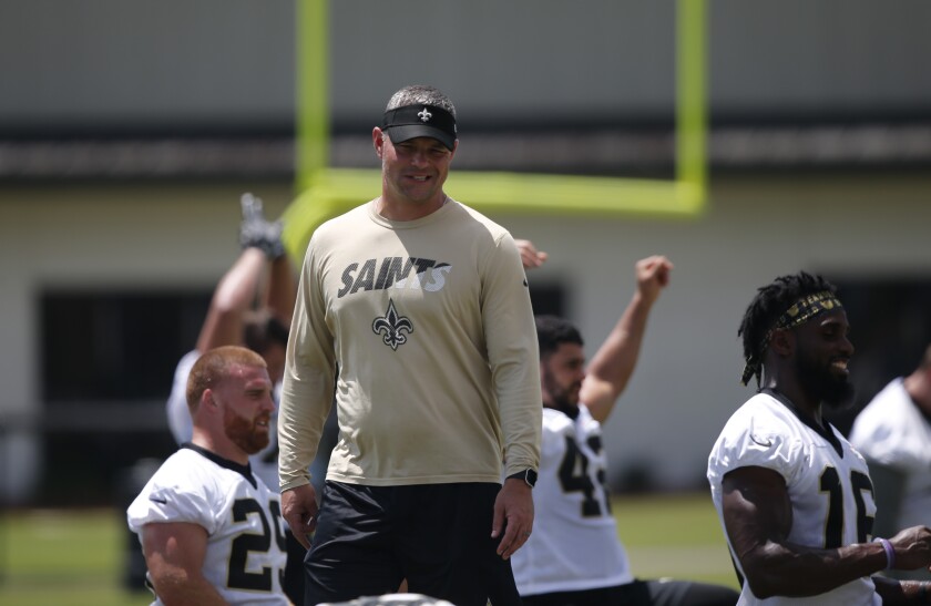 Joe Lombardi looks on during a Saints practice session.