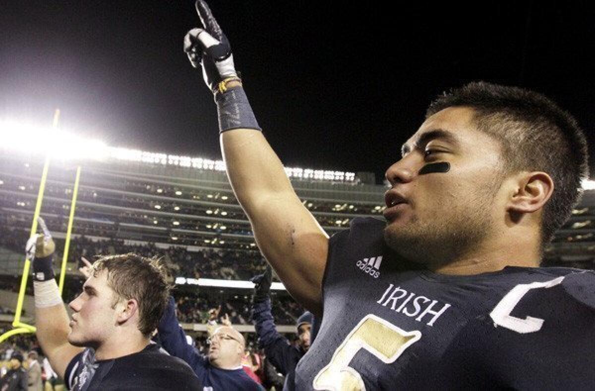 Notre Dame linebacker Manti Te'o celebrates a 41-3 victory over Miami with teammates and fans in October.