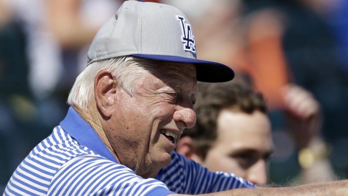Former Dodgers manager Tommy Lasorda watches an exhibition game between the Dodgers and San Francisco Giants on March 9.