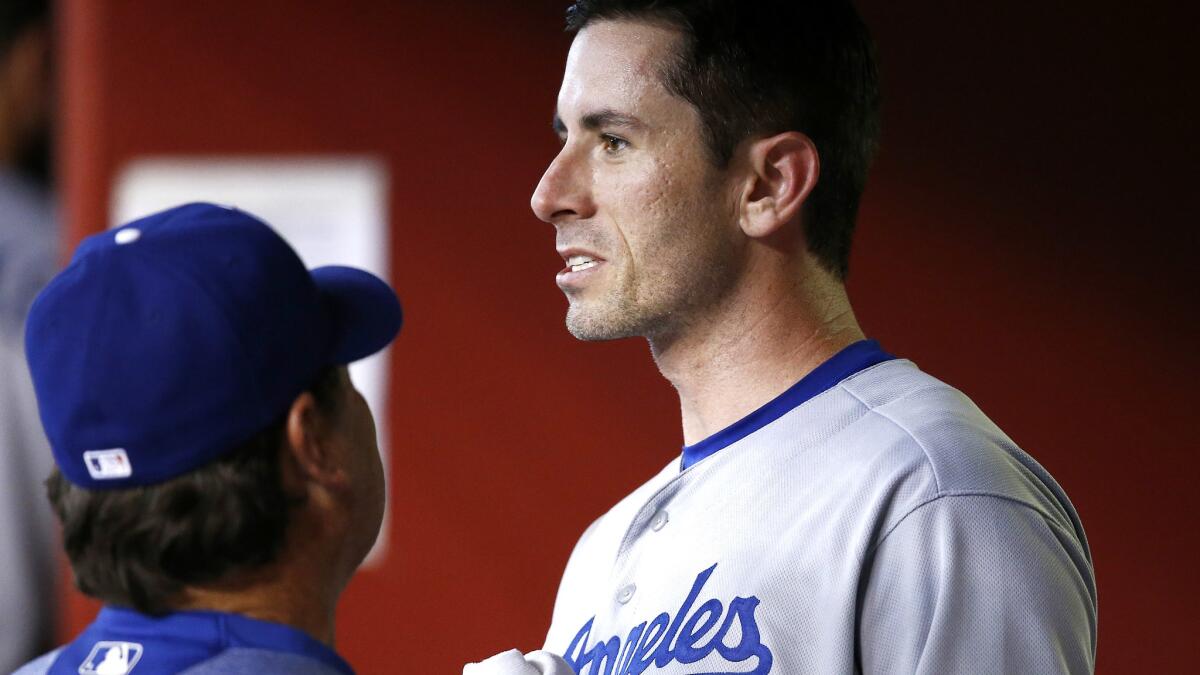 Dodgers pitcher Brandon McCarthy talks with pitching coach Rick Honeycutt in the dugout after the seventh inning on April 23.