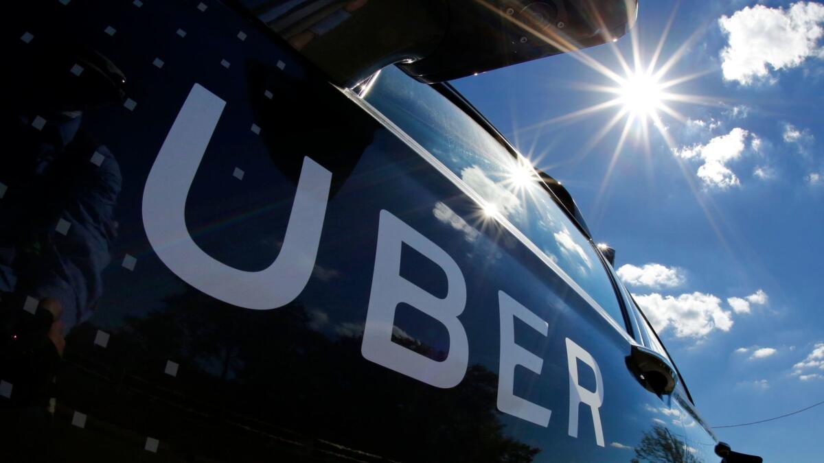 A self-driving Uber vehicle sits ready to take journalists for a ride in Pittsburgh in 2016.