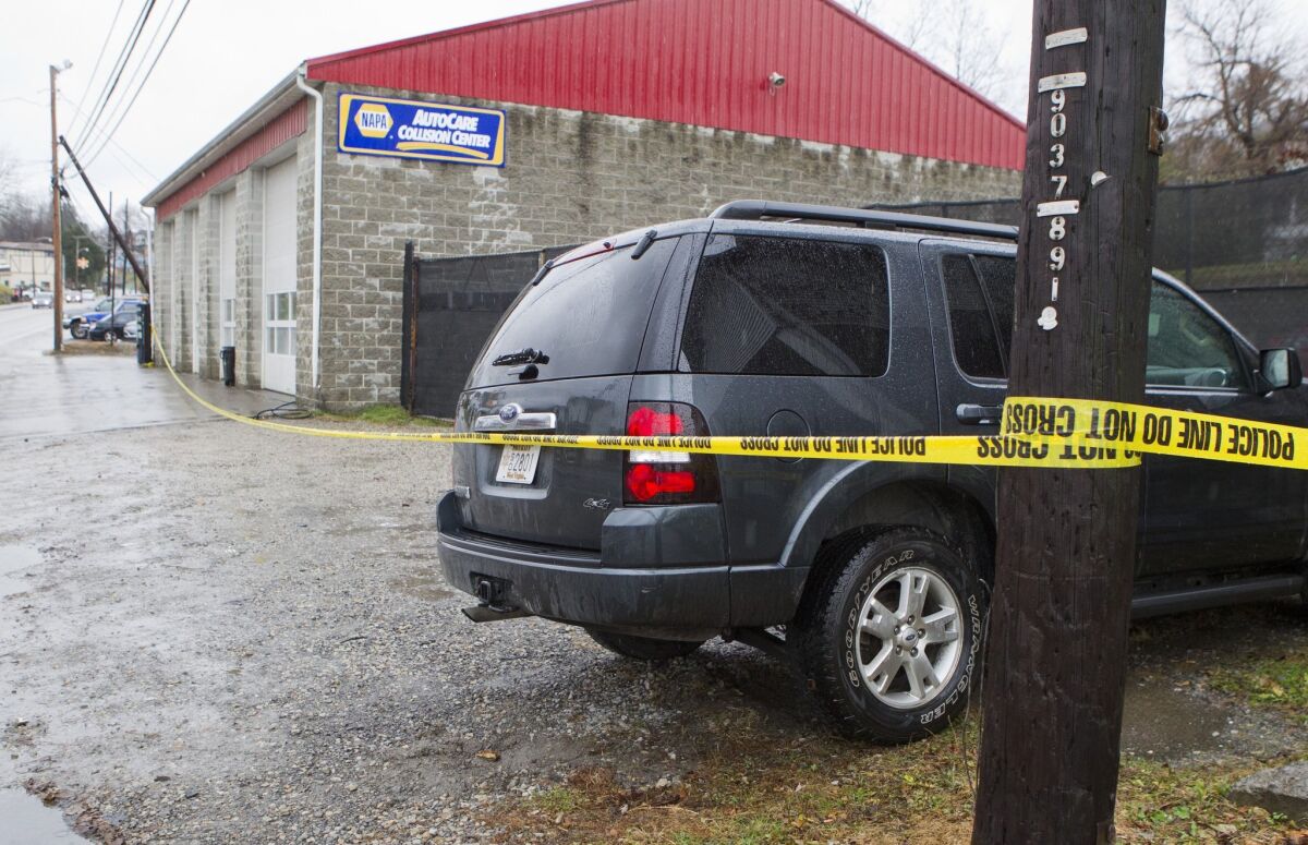 Doug's Towing in Westover, W.Va., is surrounded by police tape Monday after its owner was fatally shot by a rival who also killed three other people, authorities said.