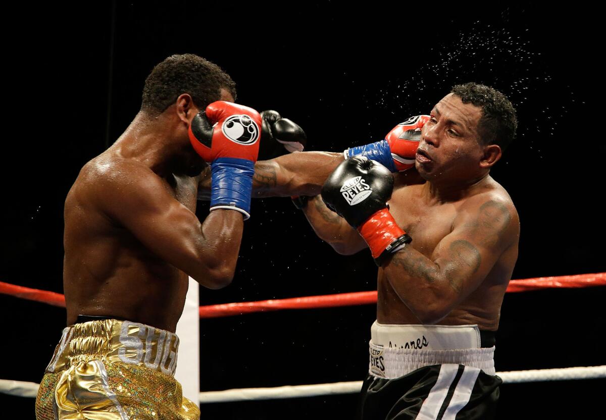 Shane Mosley lands a left hand to the head of Ricardo Mayorga during their bout at the Forum on Saturday night.