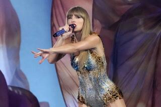 Taylor Swift wears a sparkling romper as she reaches her arm out while singing onstage