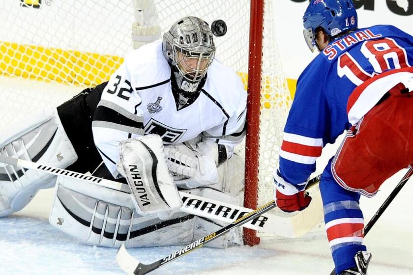Kings goaltender Jonathan Quick deflects a shot by Rangers defenseman Marc Staal into the air in the first period of Game 4 on Wednesday night in New York.