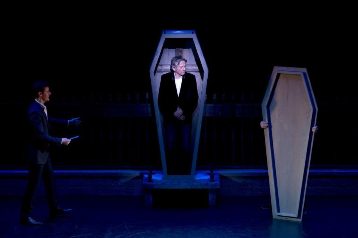Roman Polanski stands in a coffin as he takes part in a Paris press conference on Monday to present the musical "Le Bal des Vampires."