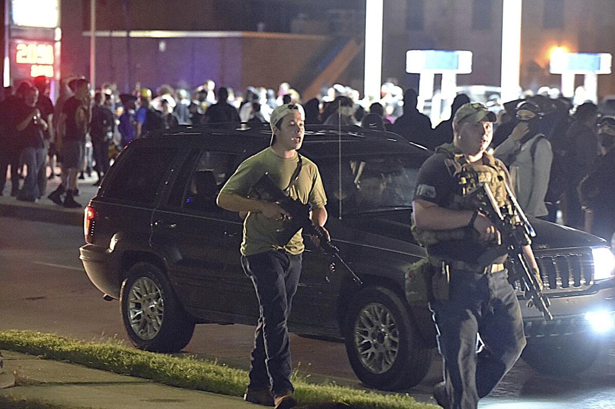 Kyle Rittenhouse, left, walking in Kenosha, Wis., on Aug. 25, 2020. 