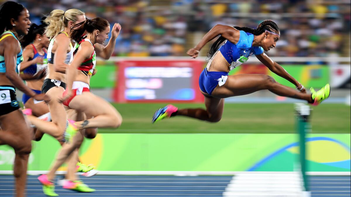 American Brianna Rollins cruises to victory in a semifinal heat of the women's 100-meter hurdles.