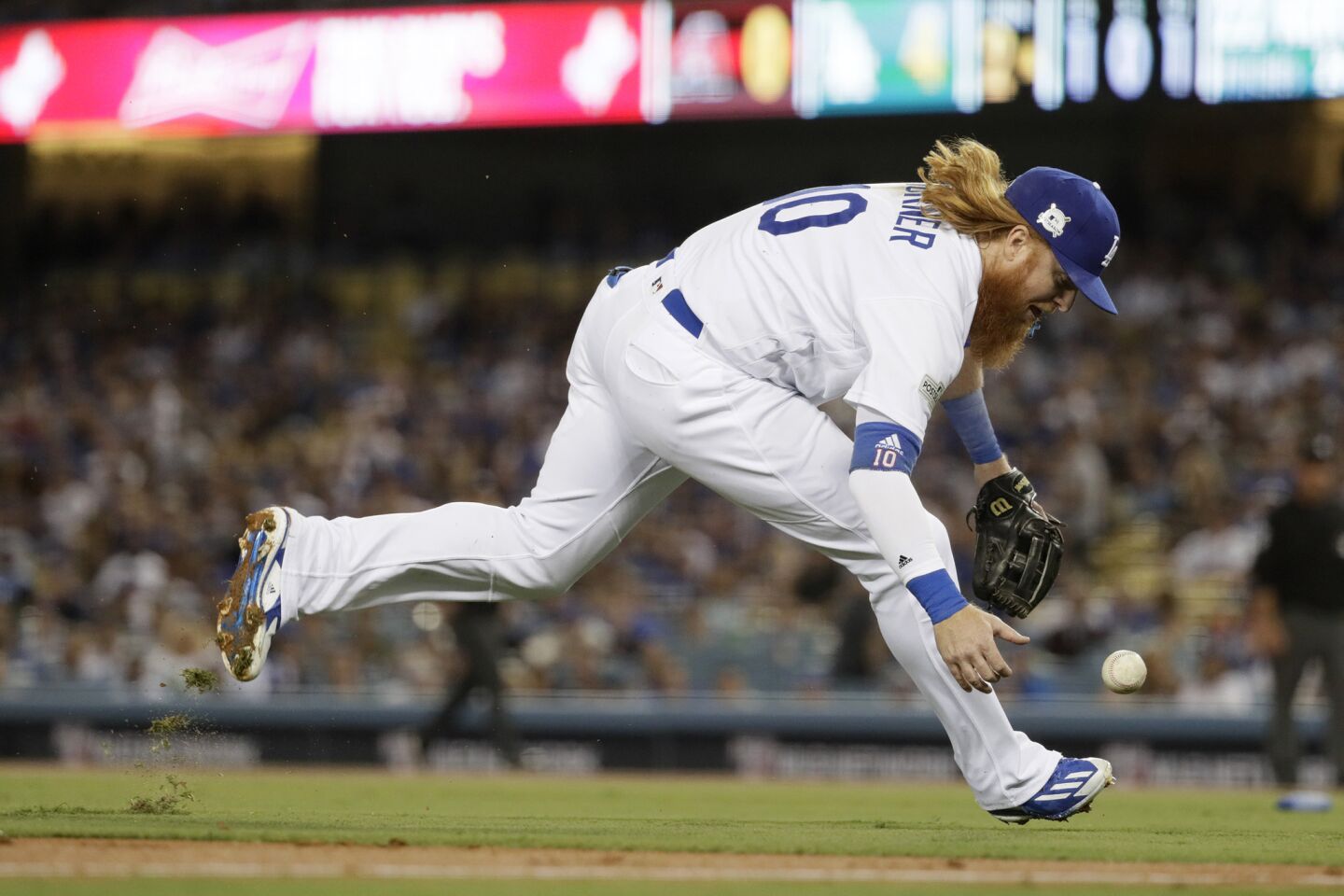 Dodgers third baseman Justin Turner bobbles a second inning grounder by Arizona's Adam Rosales for an error during Game 1 of their National League division series at Dodger Stadium.