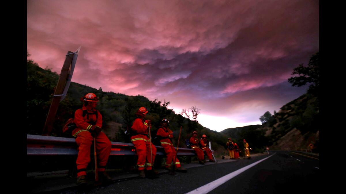 Firefighters hold a line along California 20 in Clear Lake to make sure the fire doesn’t double back. About 12,000 people have been told to evacuate their homes and campgrounds. The fire was 5% contained.