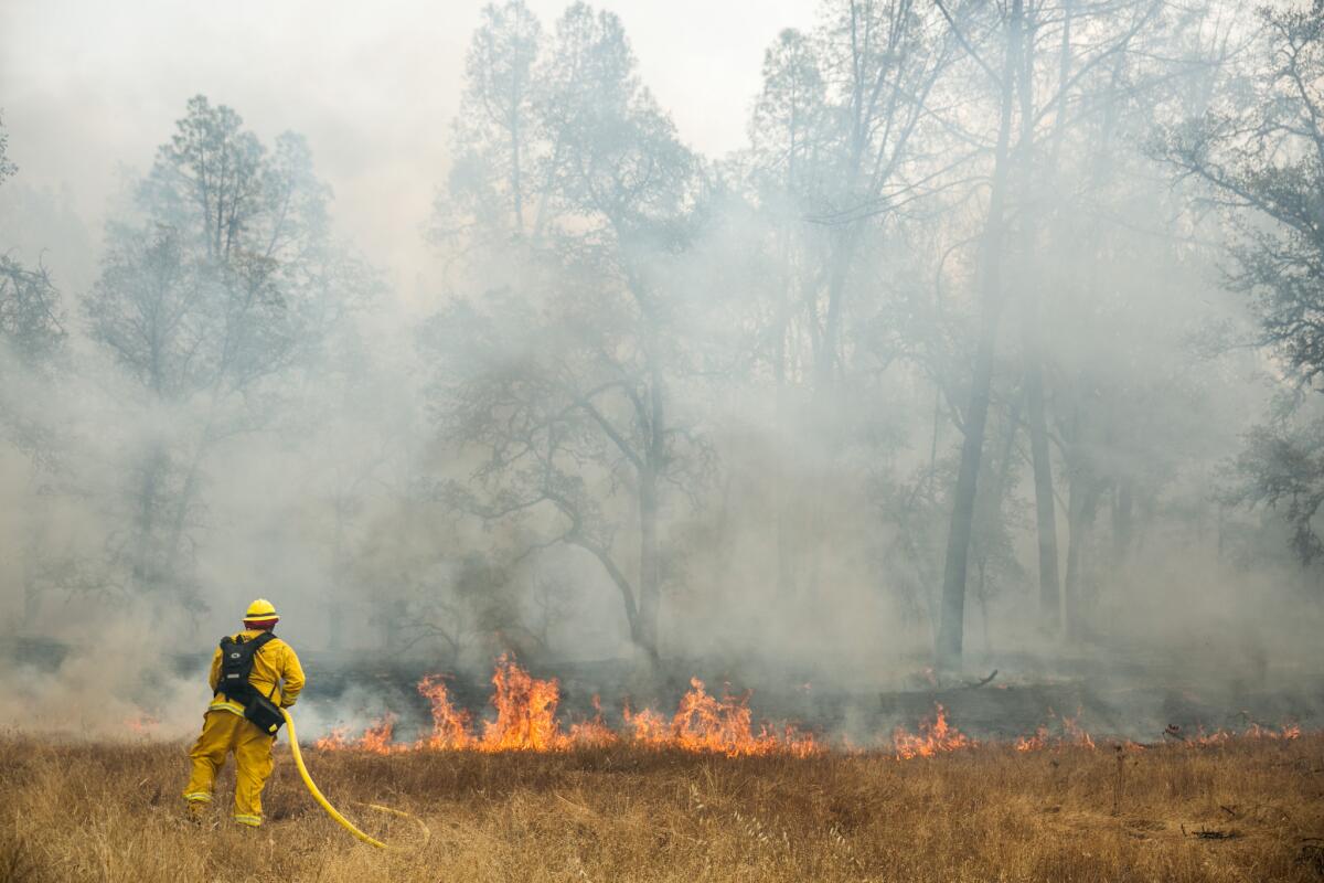 Fire crews work to contain a spreading wildfire on the outskirts of Middletown, Calif. on Monday.