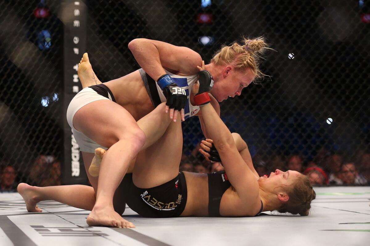 Holly Holm, top, upset Ronda Rousey at UFC 193 in Melbourne, Australia.