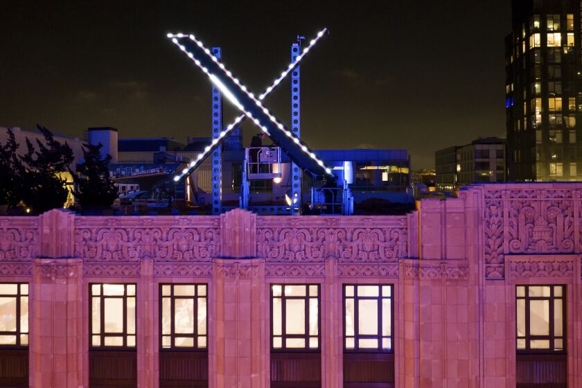 Trabajadores instalan una "X" luminosa en el techo de la empresa, antes llamada Twitter, en el centro de San Francisco, 28 de julio de 2023. Se ha retirado el cartel días después de su instalación. (AP Foto/Noah Berger)