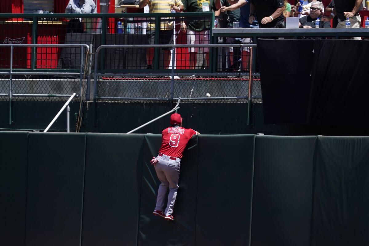 Angels right fielder Adam Eaton watches an Oakland A's home run by Matt Olson on Tuesday. (AP Photo/Jeff Chiu)