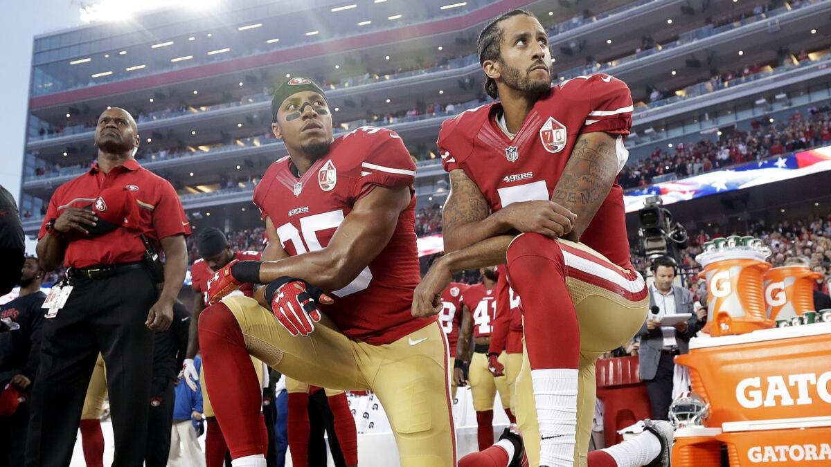 San Francisco 49ers safety Eric Reid (35) and quarterback Colin Kaepernick (7) kneel during the National Anthem on Sept. 12, 2016.